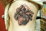 black and grey anatomical heart with time bomb tattoo - Tatt