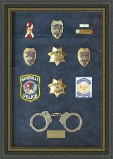 Badges, patches, and pins beautifully framed in a shadow box