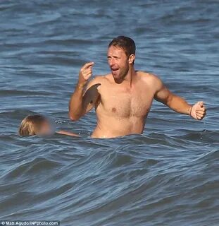 Shirtless Chris Martin enjoys a beach day with daughter Appl