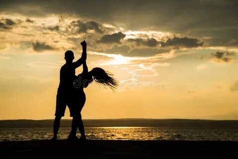 A Couple Dancing by the Sea at Sunset Stock Image - Image of