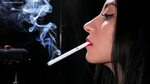 Black-haired Russian girl is smoking a 100mm cigarette in th