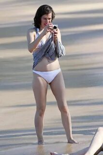 Milla Jovovich on the beach in a bikini on New Years Eve in 