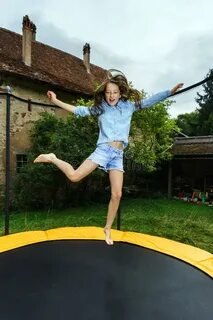 Cute Teenage Girl Jumping on Trampoline Stock Image - Image 