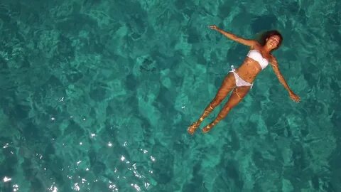 Aerial Young Woman Floating Crystal Clear Water - Home Livin