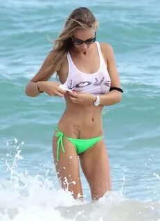 Laura Cremaschi wearing green bikini bottom and wet white se