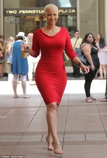 Amber Rose shows off her bombshell curves in fitted red froc