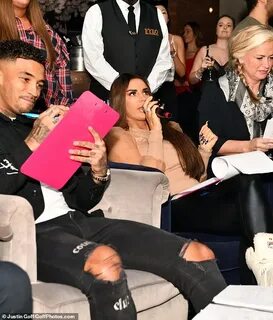 Katie Price enjoys a raunchy lap dance as she helps judge th