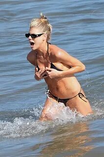 charlotte mckinney slips into a black bikini as she hits the