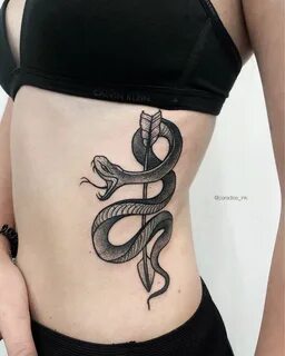 Snake, wrapped around an arrow tattoo on the left side Snake