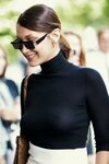 Bella Hadid braless in a slightly sheer black top and white 