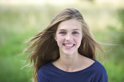 Portrait of a pretty teenage girl outside smiling - Group Th