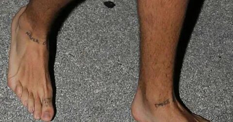 Matching tattoos on Harry Styles, saying "Never