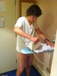 Harry Styles gives One Direction fans a treat as he irons hi