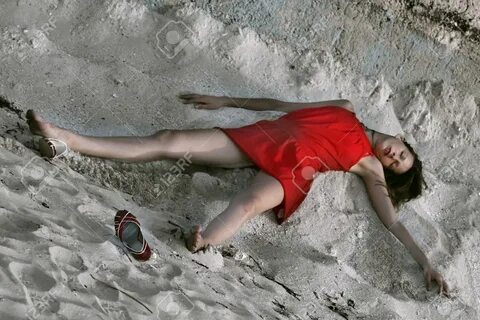 Beautiful Woman Playing Dead, Lying In The Sand Stock Photo,