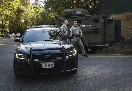 California Highway Patrol officers block off a road where El