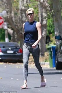 Charlize Theron shows off her lithe figure in tight leggings