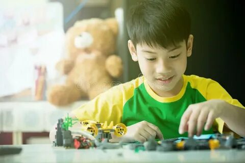 Cute Asian Boy Playing with Plastic Blocks Stock Image - Ima