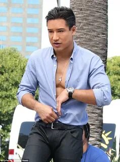 Does that cost Extra? Mario Lopez unbuttons his shirt and sh