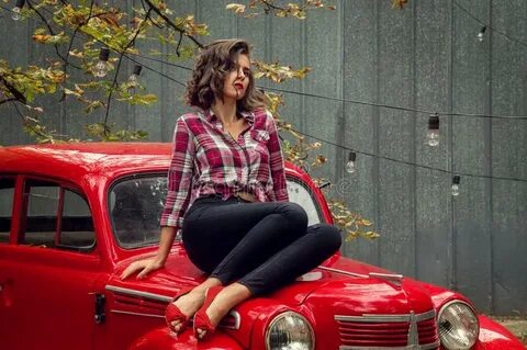 Red Cat is Sitting on the Hood of a Car Stock Photo - Image 