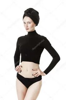 Woman with hands on hips wearing black clothes and looking S
