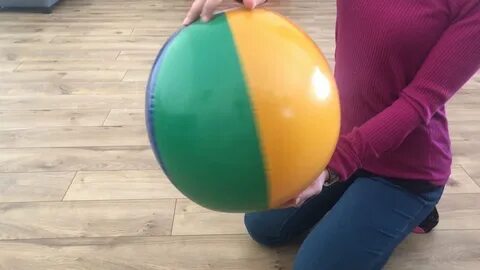 INFLATING INFLATABLE COLORFUL BEACH BALL POPPING WITH LONG N