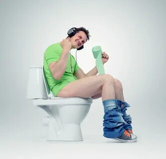 Man in Headphones Sitting on the Toilet. Stock Photo - Image