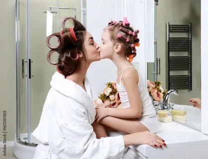 Young mother and daughter in curlers in a bath room happy sm