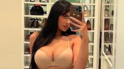 Kylie Jenner nearly busts out of her nude bra and baggy jeans in sultry sel...