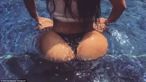Kim Kardashian shows off her impressive assets in wet shirt 