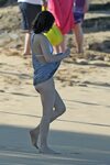 Milla Jovovich on the beach in a bikini on New Years Eve in 