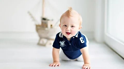 Cute Baby Boy Is Crawling On White Floor Wearing Blue White 