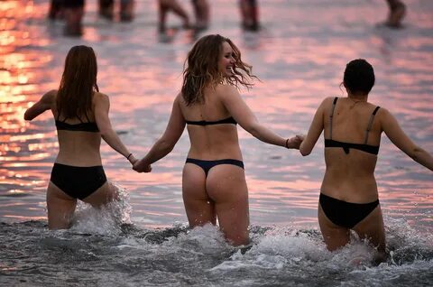 Students strip off and skinny dip in freezing sea as traditi