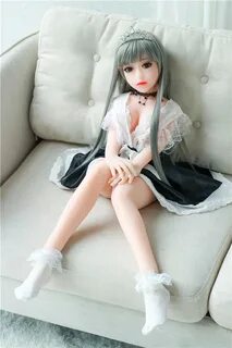 Mini sex doll with legs bent and hands on knees.