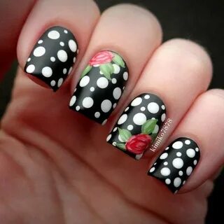 black base with white polka dots and double rose accent nail