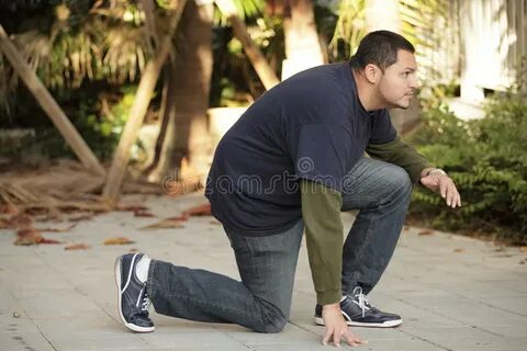 Man in a squatting pose stock photo. Image of selective - 35