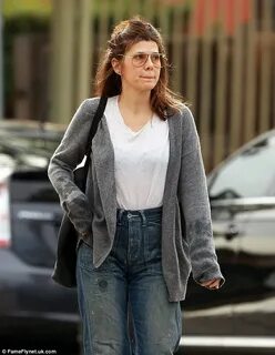 Make-up free Marisa Tomei wears drab cardigan and grungy boy