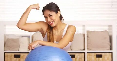 Strong Japanese Woman Showing Off Muscles Stock Photo - Imag