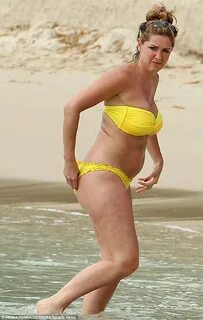 Claire Sweeney makes a splash in a bold yellow bikini as she