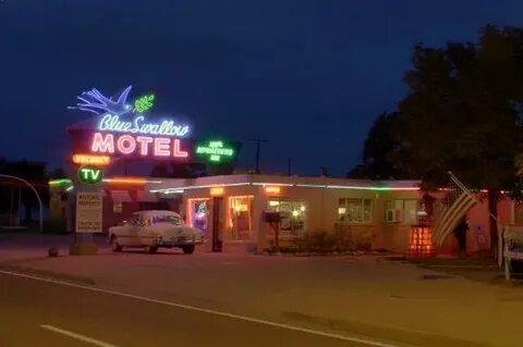 Brightly-glowing neon welcomes guests to the Blue Swallow Mo