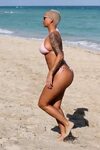 Amber Rose showing off her hourglass curves in tiny pink bik