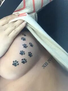 Paw print boob tattoo