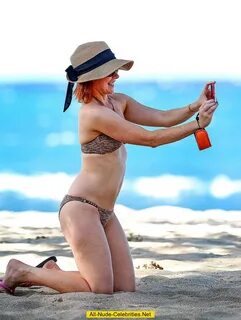 Alyson Hannigan in bikini on a beach
