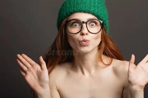 Ginger Woman Wearing Glasses and Green Hat Pouting Her Lips 