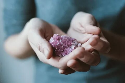 Woman Holding Pink Crystal In Her Hands by Lyuba Burakova
