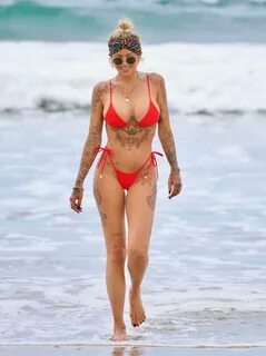 Tina Louise shows off her awesome body in a red thong bikini