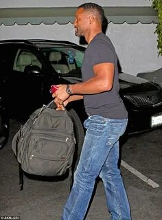 Will Smith shows off his bulging biceps and buff body in a t