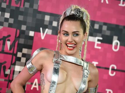 Miley Cyrus shakes in barely there silver straps at VMAs - B