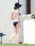 Milla Jovovich in Bikini at Poolside