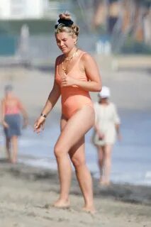 florence pugh seen wearing an orange swimsuit while enjoying