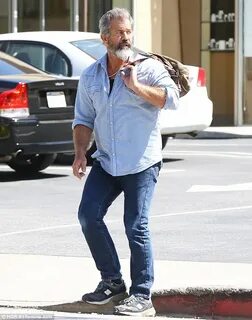 Mel Gibson displays his growing biceps as he strides into a 